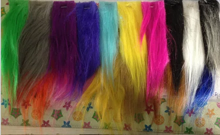 A row of long-pile fur swatches in green, grey, purple, blue, yellow, pink, white and black